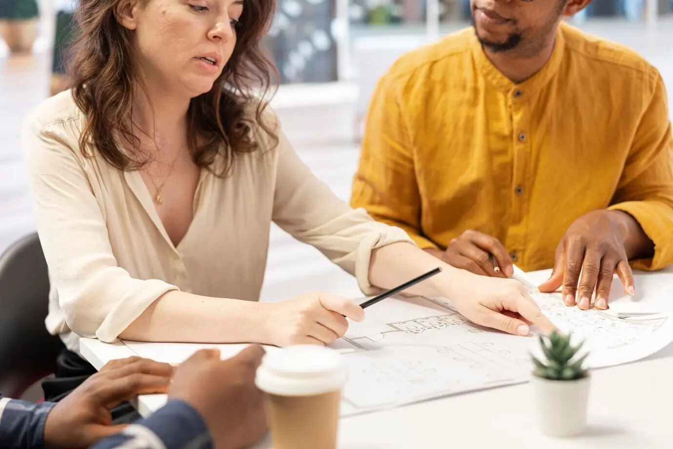 Business owner discussing ideas with a realtor and a contractor during an office tour.